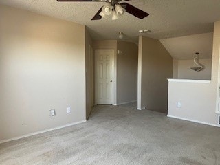 additional living space with ceiling fan, light colored carpet, a textured ceiling, and vaulted ceiling