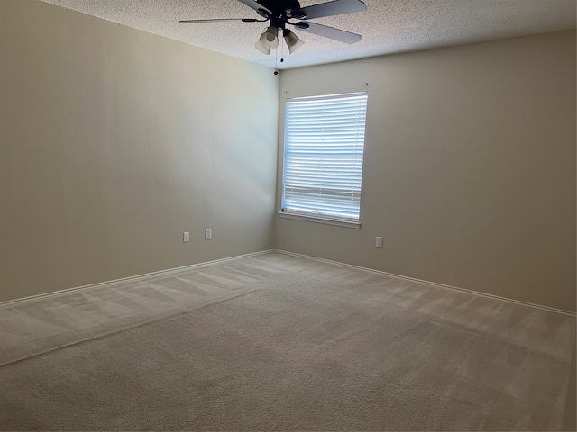 spare room with carpet, a textured ceiling, and ceiling fan