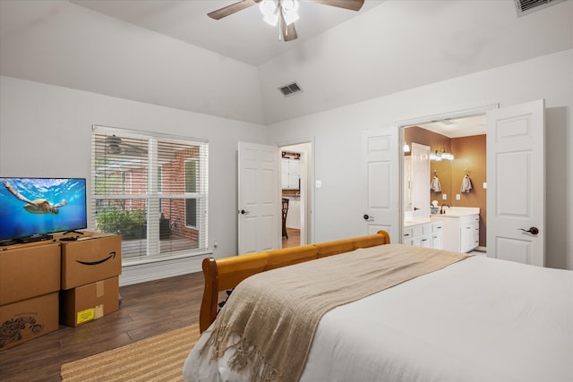 bedroom with dark wood-type flooring, lofted ceiling, sink, ensuite bathroom, and ceiling fan