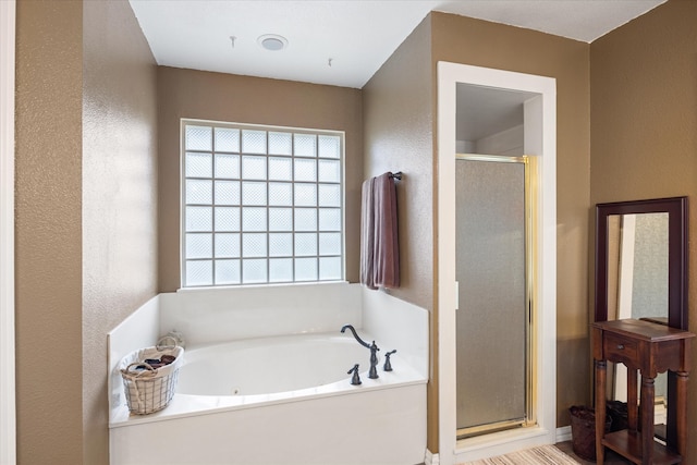 bathroom with separate shower and tub