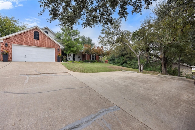 view of front facade with a garage and a front lawn