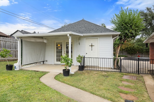 back of property with a yard and a patio area