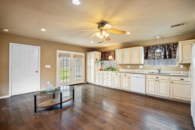 kitchen with dark wood-type flooring, white appliances, ceiling fan, and hanging light fixtures