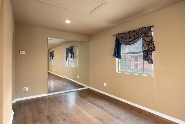 empty room with hardwood / wood-style floors