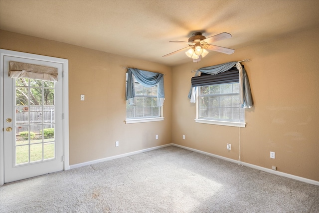 empty room featuring carpet flooring and ceiling fan