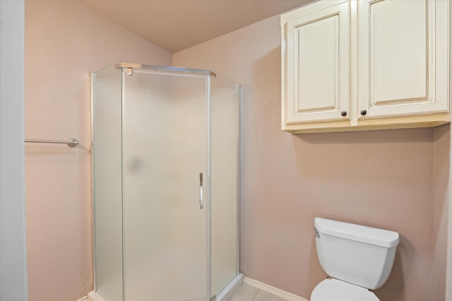 bathroom with toilet and an enclosed shower