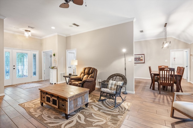 living room featuring ornamental molding, light hardwood / wood-style flooring, ceiling fan, and vaulted ceiling