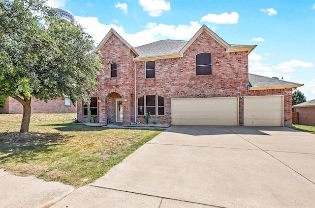 front of property with a front yard and a garage