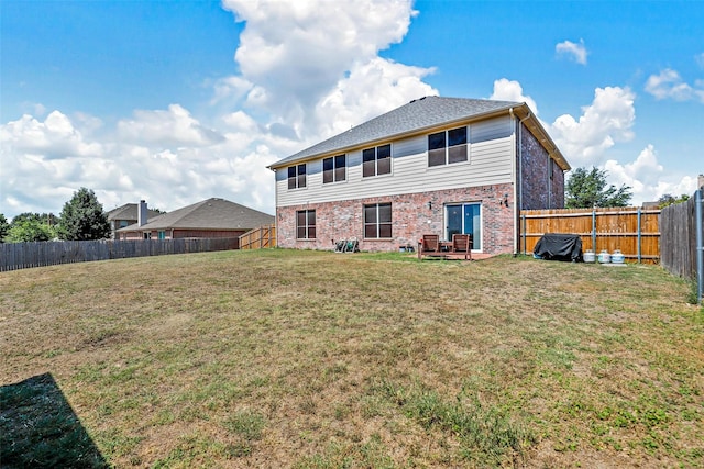 rear view of house with a patio area and a yard