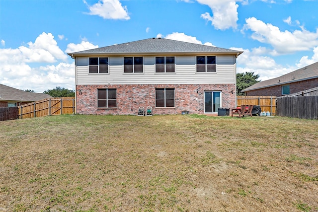 back of property featuring a lawn