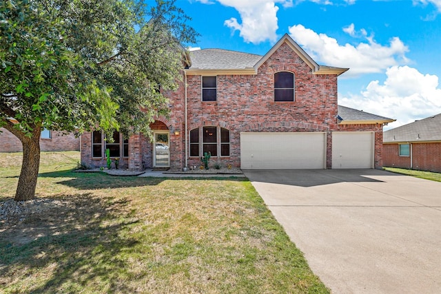 view of front facade with a garage and a front lawn