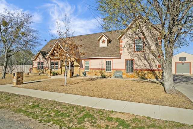 view of front of home with a garage and an outdoor structure