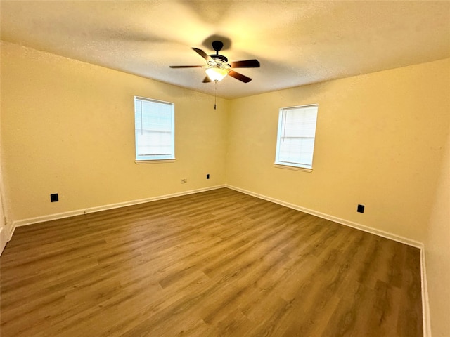 unfurnished room with wood-type flooring, a textured ceiling, and ceiling fan