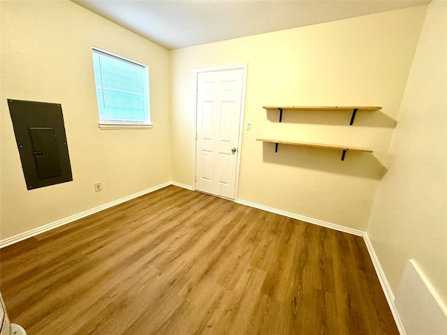 empty room featuring wood-type flooring and electric panel