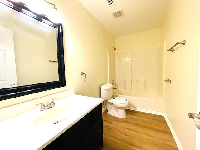 full bathroom featuring wood-type flooring, vanity, toilet, and tub / shower combination