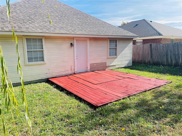 rear view of property featuring a yard and a deck