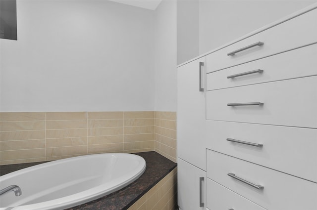 bathroom with a relaxing tiled tub