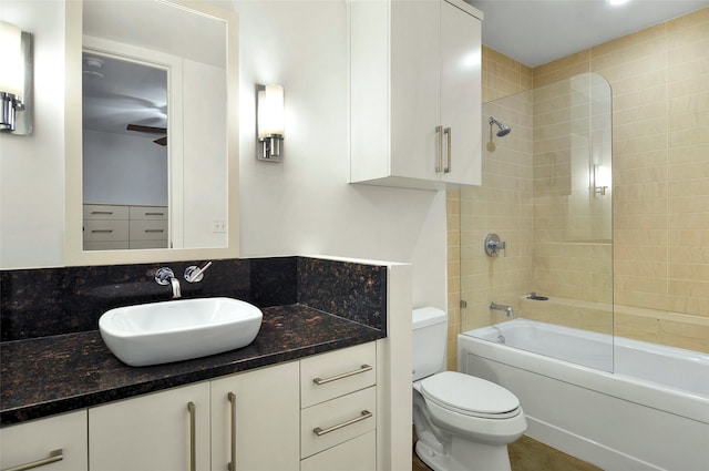 full bathroom featuring toilet, tiled shower / bath combo, and vanity