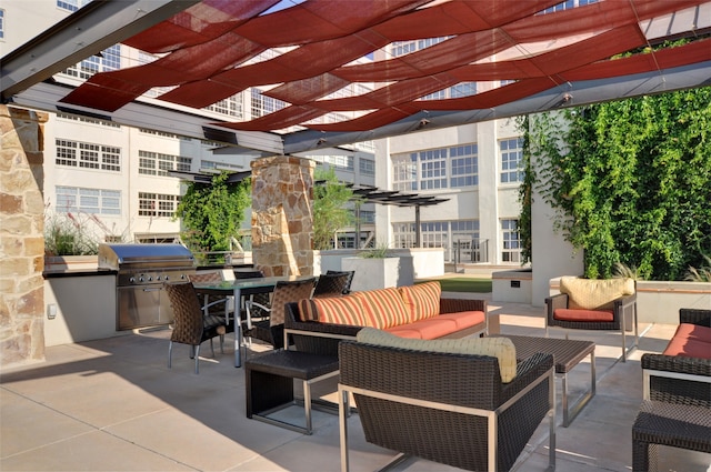 view of patio featuring outdoor lounge area, exterior kitchen, and a pergola