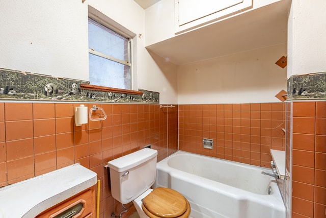 bathroom featuring a bathing tub, tile walls, and toilet