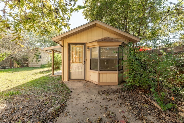 view of outbuilding with a lawn