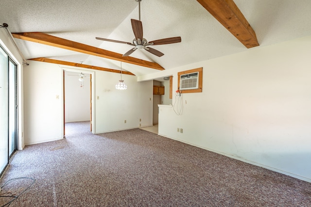 carpeted empty room featuring lofted ceiling with beams, ceiling fan, a textured ceiling, and a wall unit AC