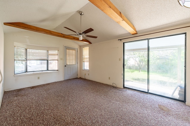 unfurnished room with ceiling fan, carpet flooring, vaulted ceiling with beams, and a textured ceiling