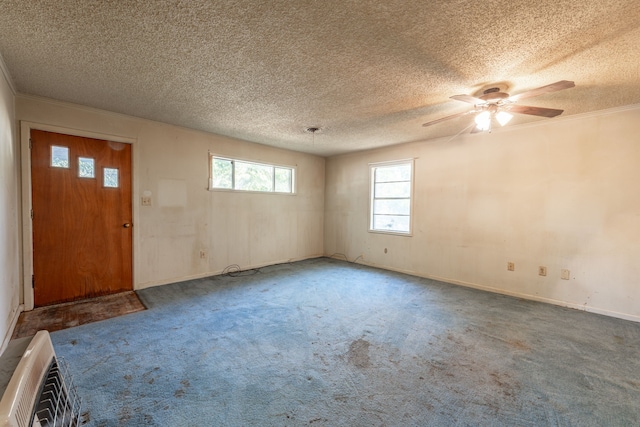 spare room featuring ceiling fan, carpet flooring, and a textured ceiling