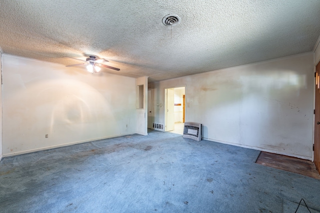 carpeted spare room featuring heating unit, ceiling fan, and a textured ceiling