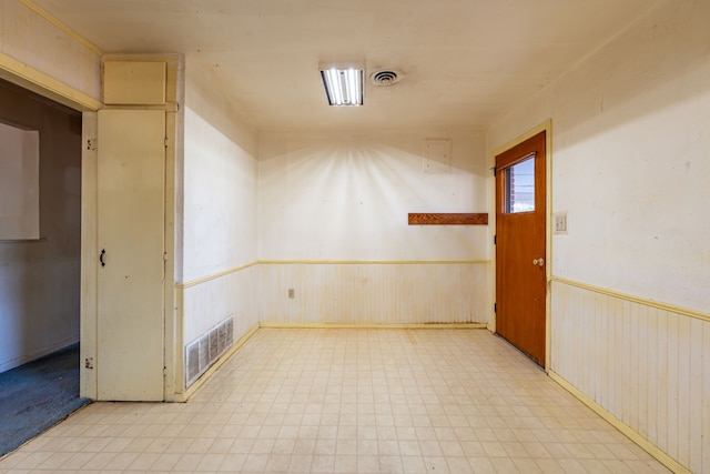 spare room with wood walls