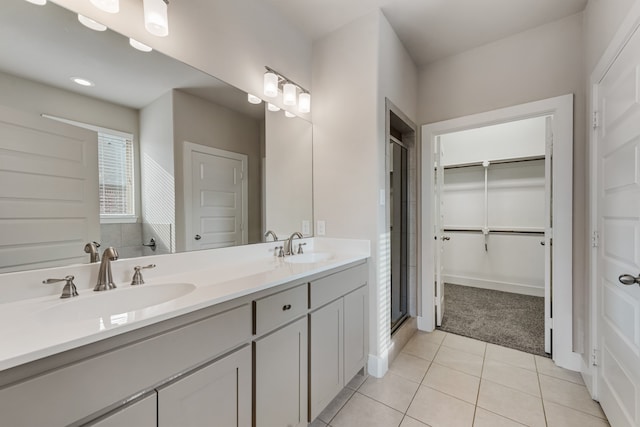 bathroom with vanity, tile patterned floors, and a shower with shower door