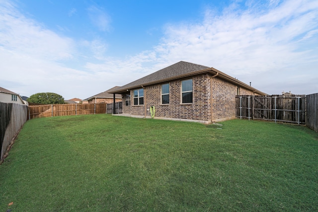 rear view of property with a yard