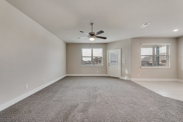 carpeted spare room with ceiling fan