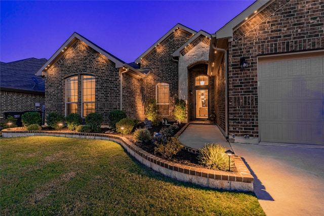 view of front of home with a garage and a yard