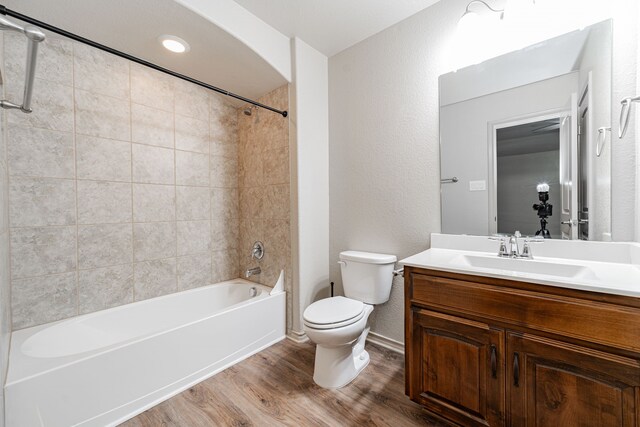 2216 Rosalinda Pass, Fort Worth, TX 76131 - full bathroom with wood finished floors, toilet, tub / shower combination, a textured wall, and vanity