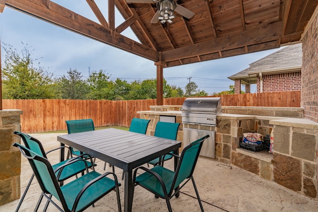 view of patio / terrace with grilling area, ceiling fan, a gazebo, and exterior kitchen