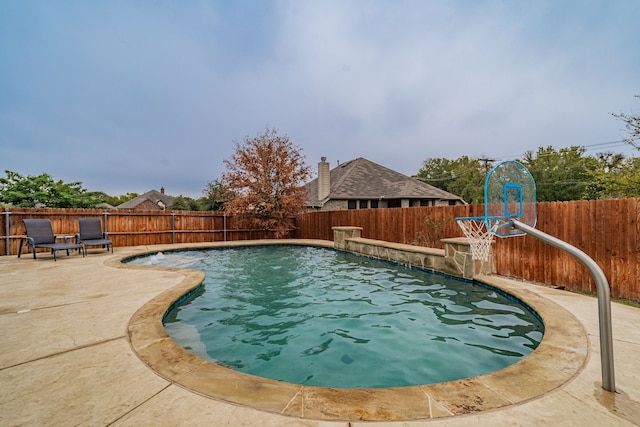 view of swimming pool with a patio and pool water feature