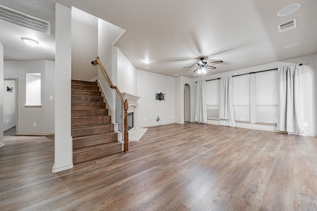 unfurnished living room with light hardwood / wood-style floors and ceiling fan