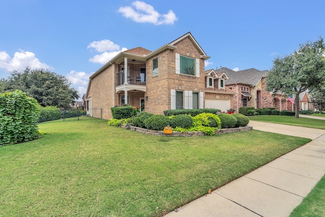 view of front of property with a garage, a front yard, and a balcony