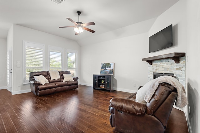 living room with a stone fireplace, ceiling fan, lofted ceiling, and dark hardwood / wood-style floors