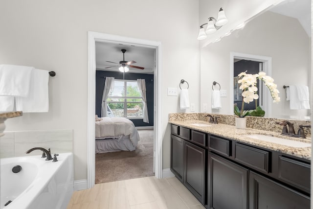 bathroom with ceiling fan, vanity, lofted ceiling, tile patterned floors, and a bathtub