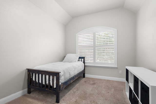 bedroom with carpet flooring and vaulted ceiling