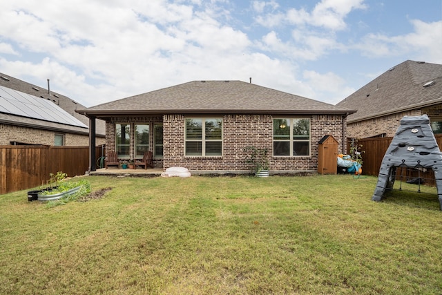 back of house with a yard and a patio area