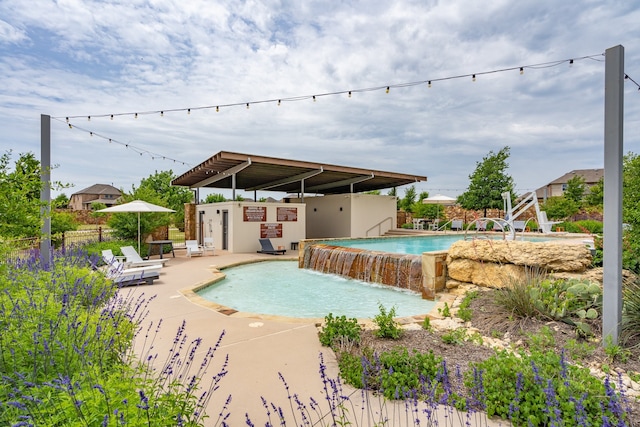 view of swimming pool with a patio and pool water feature