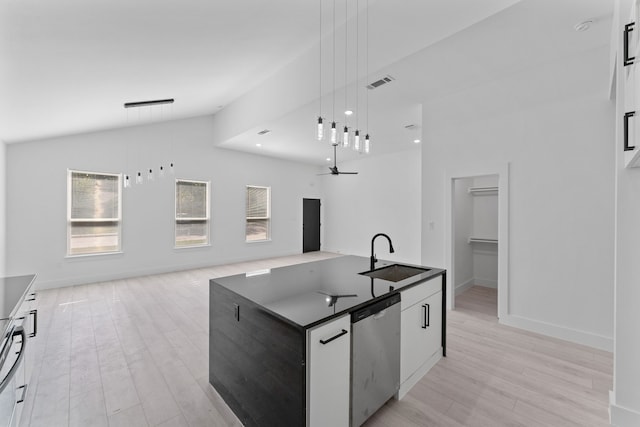 kitchen with sink, white cabinetry, hanging light fixtures, stainless steel dishwasher, and an island with sink