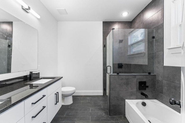 full bathroom with vanity, toilet, and separate shower and tub