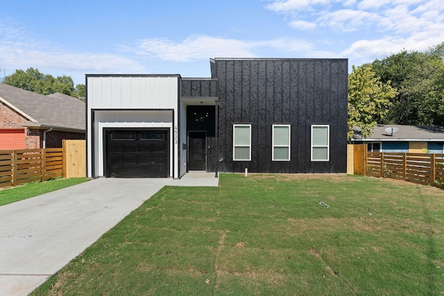 view of front facade with a garage and a front lawn