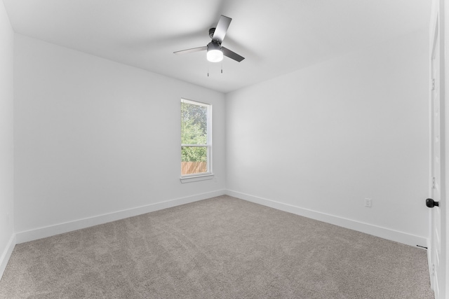 empty room featuring light colored carpet and ceiling fan