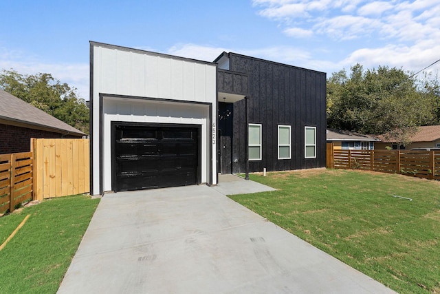 contemporary home featuring a balcony and a front lawn