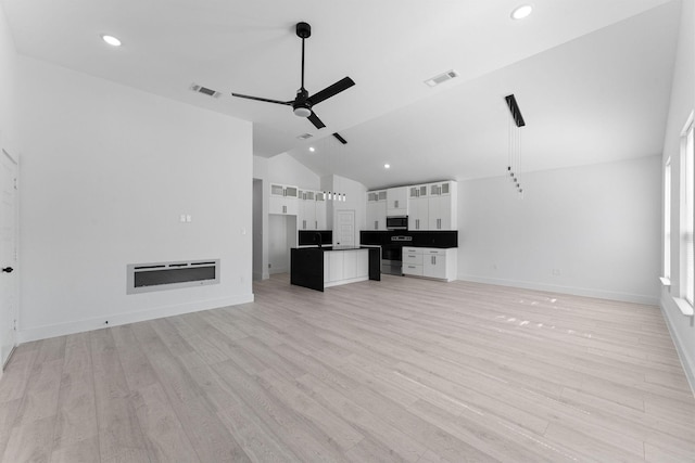 unfurnished living room featuring light hardwood / wood-style flooring, high vaulted ceiling, and ceiling fan